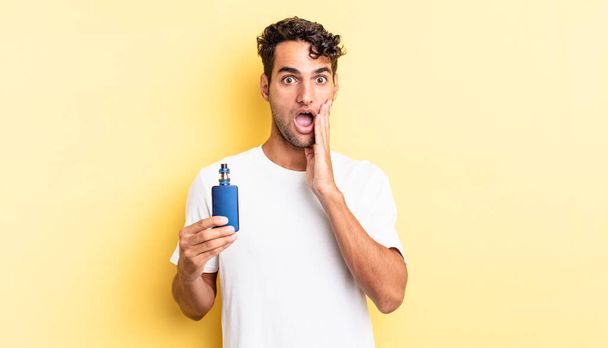 hispanic handsome man feeling shocked and scared. vaporizer concept - Foto, immagini