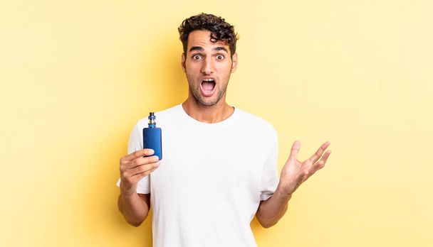 hispanic handsome man feeling extremely shocked and surprised. vaporizer concept - Фото, зображення