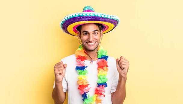 hispanic handsome man feeling shocked,laughing and celebrating success. mexican party concept - Foto, immagini