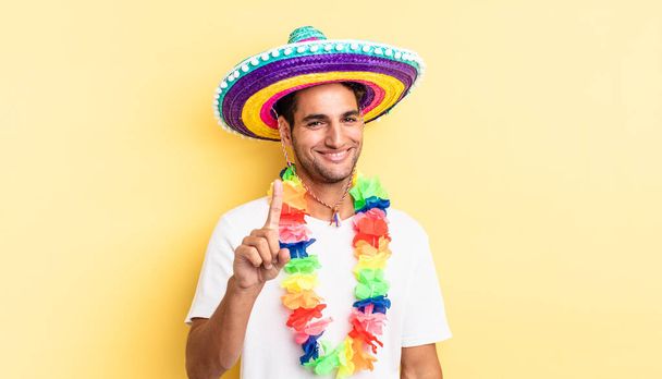 hispanic handsome man smiling proudly and confidently making number one. mexican party concept - Фото, зображення