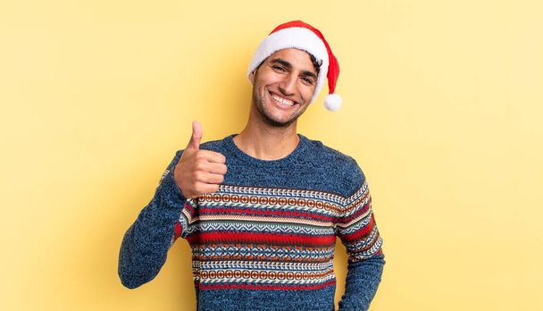 hispanic handsome man feeling proud,smiling positively with thumbs up. christmas concept - Фото, зображення