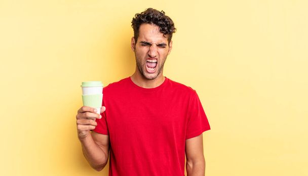 hispanic handsome man shouting aggressively, looking very angry. take away coffee concept - Photo, image