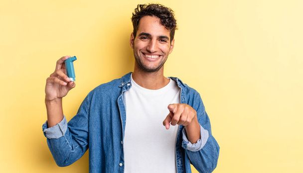 hispanic handsome man pointing at camera choosing you. asthma concept - Photo, Image
