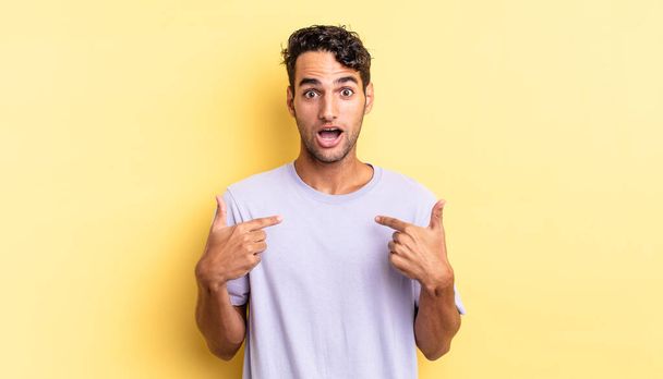 hispanic handsome man feeling happy and pointing to self with an excited - Foto, Bild