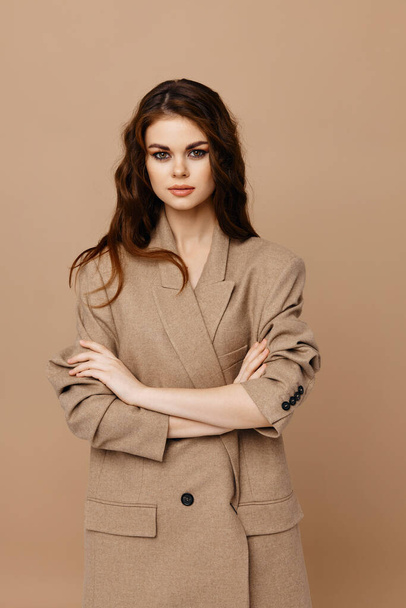 Woman crossed arms over chest and beige coat cropped view - Φωτογραφία, εικόνα