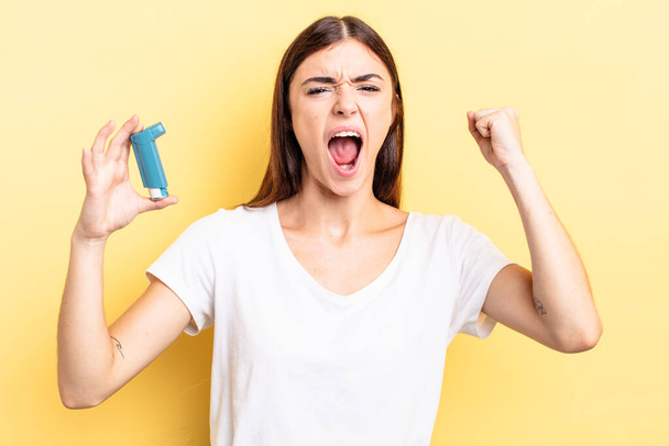 young hispanic woman shouting aggressively with an angry expression. asthma concept - Fotoğraf, Görsel