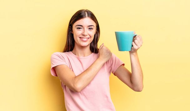young hispanic woman feeling happy and facing a challenge or celebrating. coffee cup concept - Fotó, kép