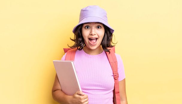 young hispanic woman looking very shocked or surprised. back to school concept - Fotoğraf, Görsel