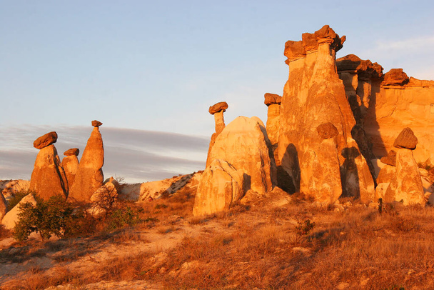 eroded fairy chimneys or pinnacles, harder stones balancing on top - Photo, Image