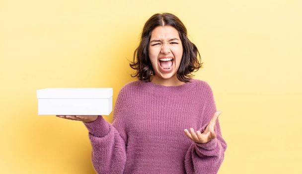 young hispanic woman looking angry, annoyed and frustrated. blank box concept - Photo, Image