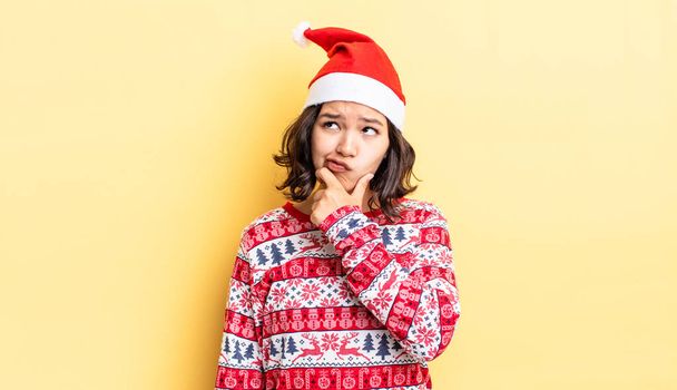 young hispanic woman thinking, feeling doubtful and confused. christmas concept - Foto, immagini