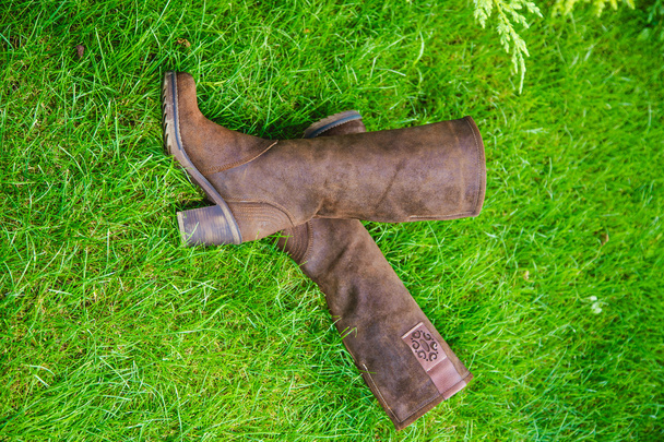 Suede boots women lie on the grass - Foto, Imagen
