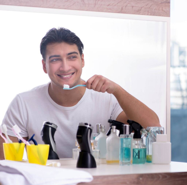 Handsome man brushing teeth in the morning - Photo, Image