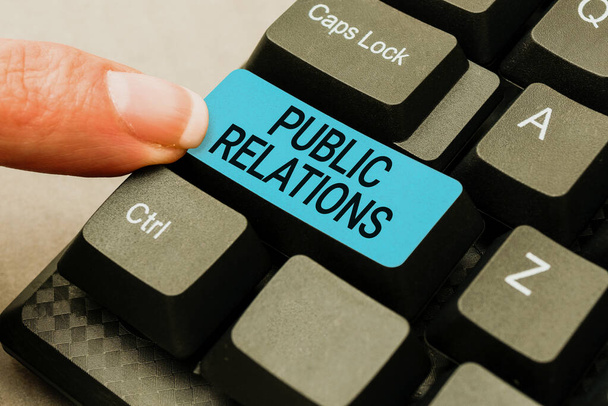 Text sign showing Public Relations. Word for state of the relationship between the public and a company Compiling And Typing Online Research Materials, Sending Chat Messages - Photo, Image