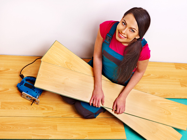 Builder woman with floor planks - Photo, Image