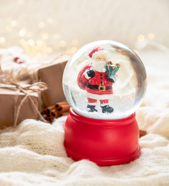 christmas and new year toy snow ball with santa, gift box, winter and festive mood, cristmas vibe - Zdjęcie, obraz