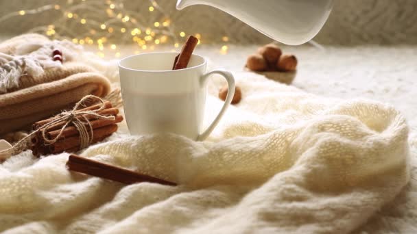 молоко, кофе, какао или горячий шоколад в белой кружке, скандинавский стиль уютное утро с некоторыми вязаными одеялами, кружка какао, подарочная коробка, зимнее и праздничное настроение, Кристмас вибрации - Кадры, видео