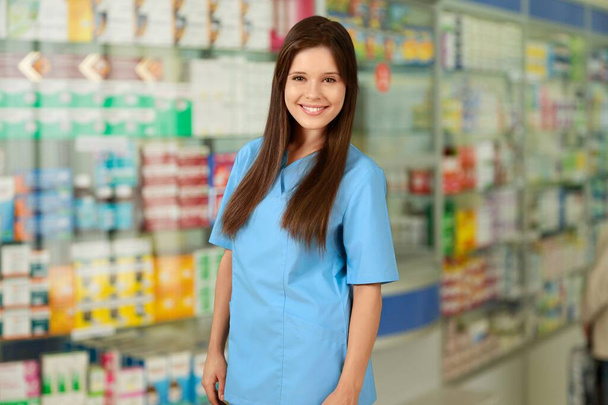 portrait of smiling pharmacist in drugstore on background, close up - Foto, immagini