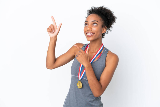 Young African American woman with medals isolated on white background pointing with the index finger a great idea - Photo, Image