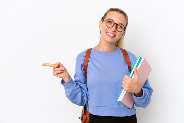 Young student caucasian woman isolated on white background pointing finger to the side - Foto, imagen