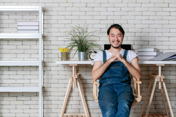 Young hipster beard Asian man sitting with happy in his new modern minimal startup office, concept for happy businessman at beginning. - Φωτογραφία, εικόνα