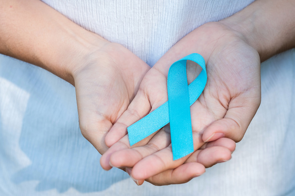 November Prostate Cancer Awareness month, woman holding Blue Ribbon for supporting people living and illness. Healthcare, International men, Father, World cancer day and world diabetes day concept - Photo, Image