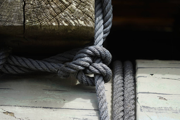 A close-up shot of a thick rope with nodes and a connection of two threads - Valokuva, kuva