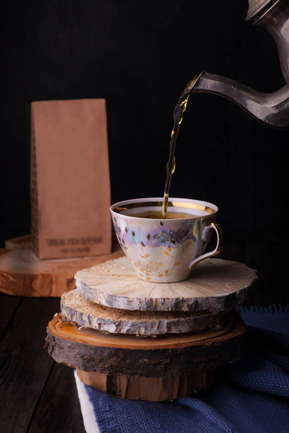 cup of coffee and a jug of tea on a wooden table - Photo, Image