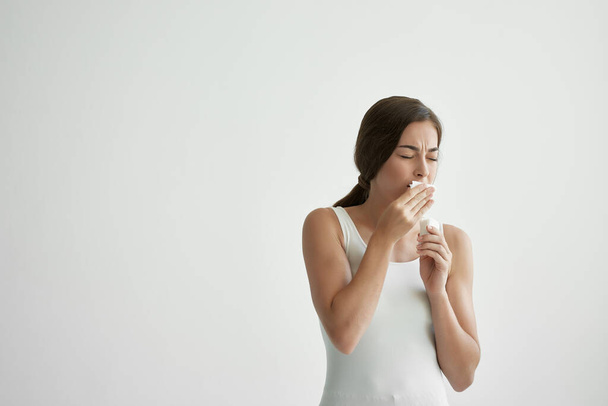 woman in white T-shirt wipes her face with a handkerchief fever - Фото, зображення