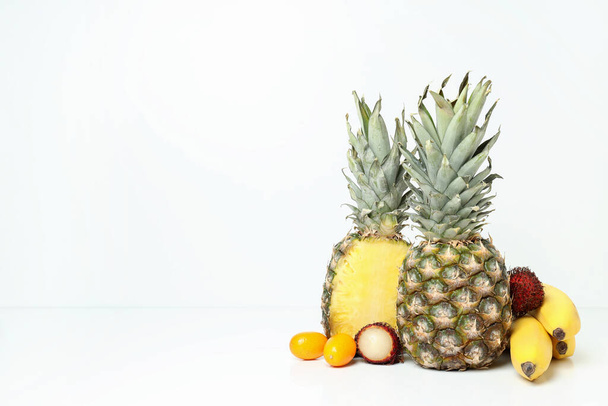 Exotic fruits on white background, space for text.. - Foto, imagen
