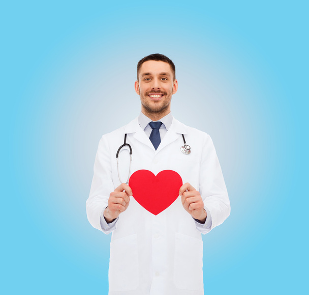 smiling male doctor with red heart - Foto, imagen