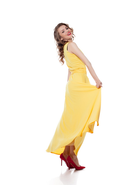 Happy young model posing in trendy yellow dress - Фото, изображение