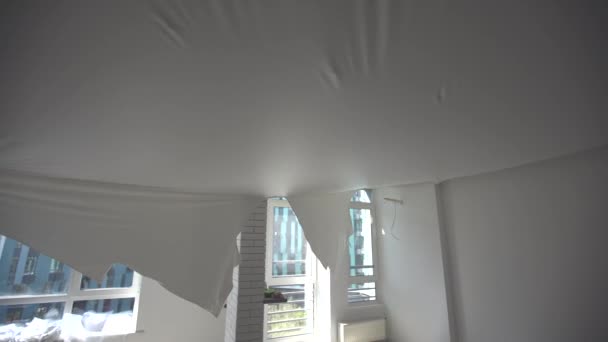 repairmen install stretch ceiling made of pvc vinyl film using a gas heat gun - Footage, Video