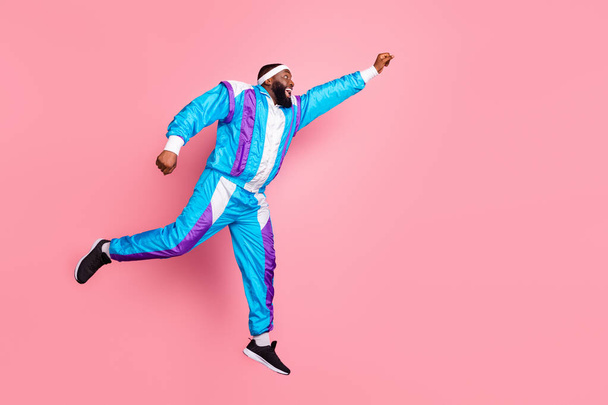 Full body profile side photo of young black man happy positive smile jump run superhero isolated over pink color background - 写真・画像