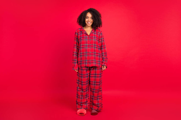 Full body photo of happy young afro american woman wear sleepwear holiday spirit smile isolated on red color background - Fotoğraf, Görsel
