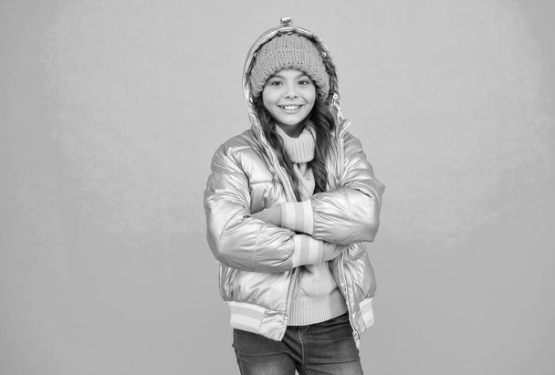 happy kid in silver puffer jacket and knitwear get warm in winter ready for activity on holidays, xmas vacation - Foto, Imagen