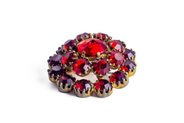 Vintage metal brooch with ruby-colored stones, isolated on a white background - Zdjęcie, obraz