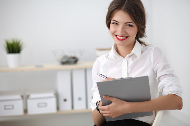 Portrait of a young woman working at office - Foto, immagini