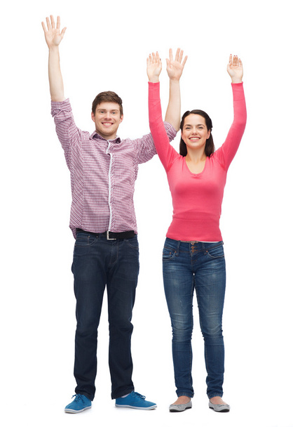 smiling teenagers with raised hands - Photo, Image