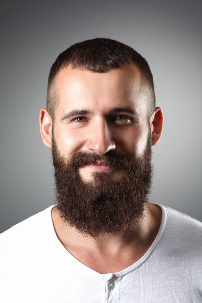Portrait of handsome bearded man standing, isolated on grey background - Zdjęcie, obraz