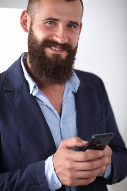 Close up of a man using mobile smart phone, isolated on white background - Φωτογραφία, εικόνα
