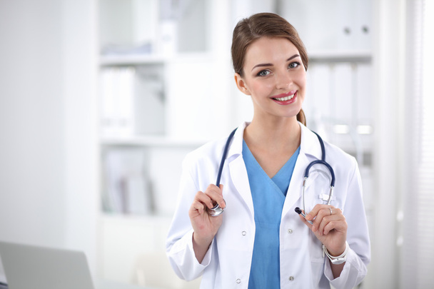 Portrait of happy successful young female doctor holding a stethoscope - Photo, image