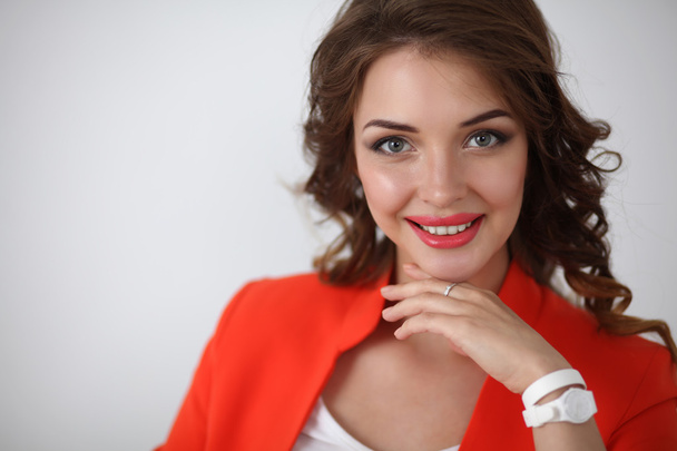 Portrait of  happy smiling beautiful woman wearing a red jacket - Fotografie, Obrázek