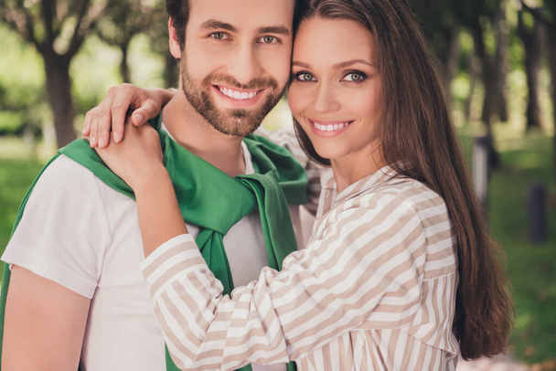 Photo portrait couple smiling spending time in park wearing casual clothes on date in summer sunny weather - Фото, зображення