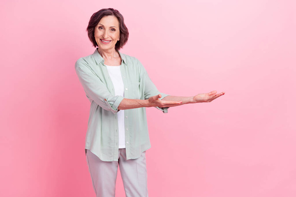 Photo of pretty positive person hands palms hold demonstrate empty space isolated on pink color background - Φωτογραφία, εικόνα