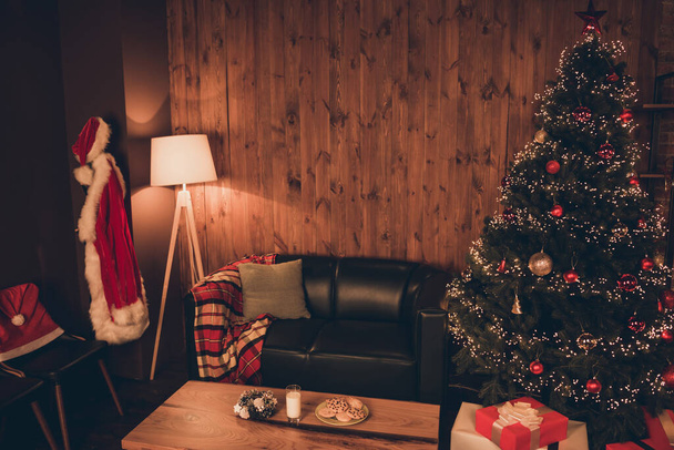 Photo of comfortable house christmas tree milk cookies santa claus christmas spirit atmosphere indoors inside home apartment - Фото, изображение