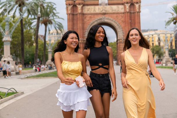 Happy multiethnic women in fashionable wear in city - Photo, Image