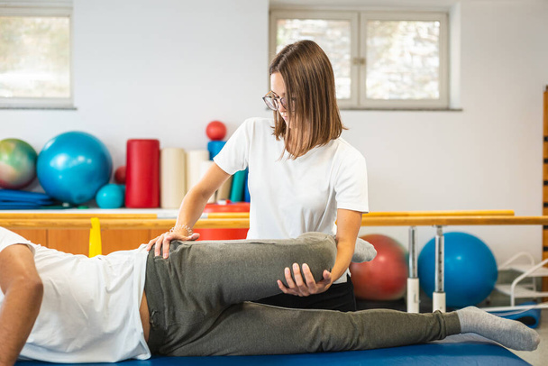 Leg and hip stretching physio treatment - Fotoğraf, Görsel
