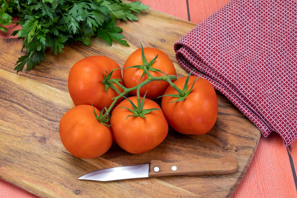 bunch of red tomatoes on a wooden table - Photo, image