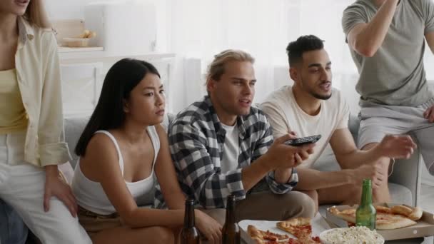 Group Of Young Multiethnic Friends Watching Tv Together At Home Party - Footage, Video